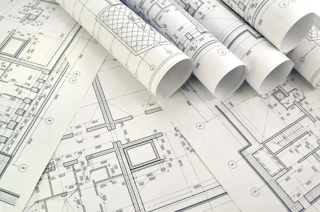 Drafting studio with detailed residential plan and rendering