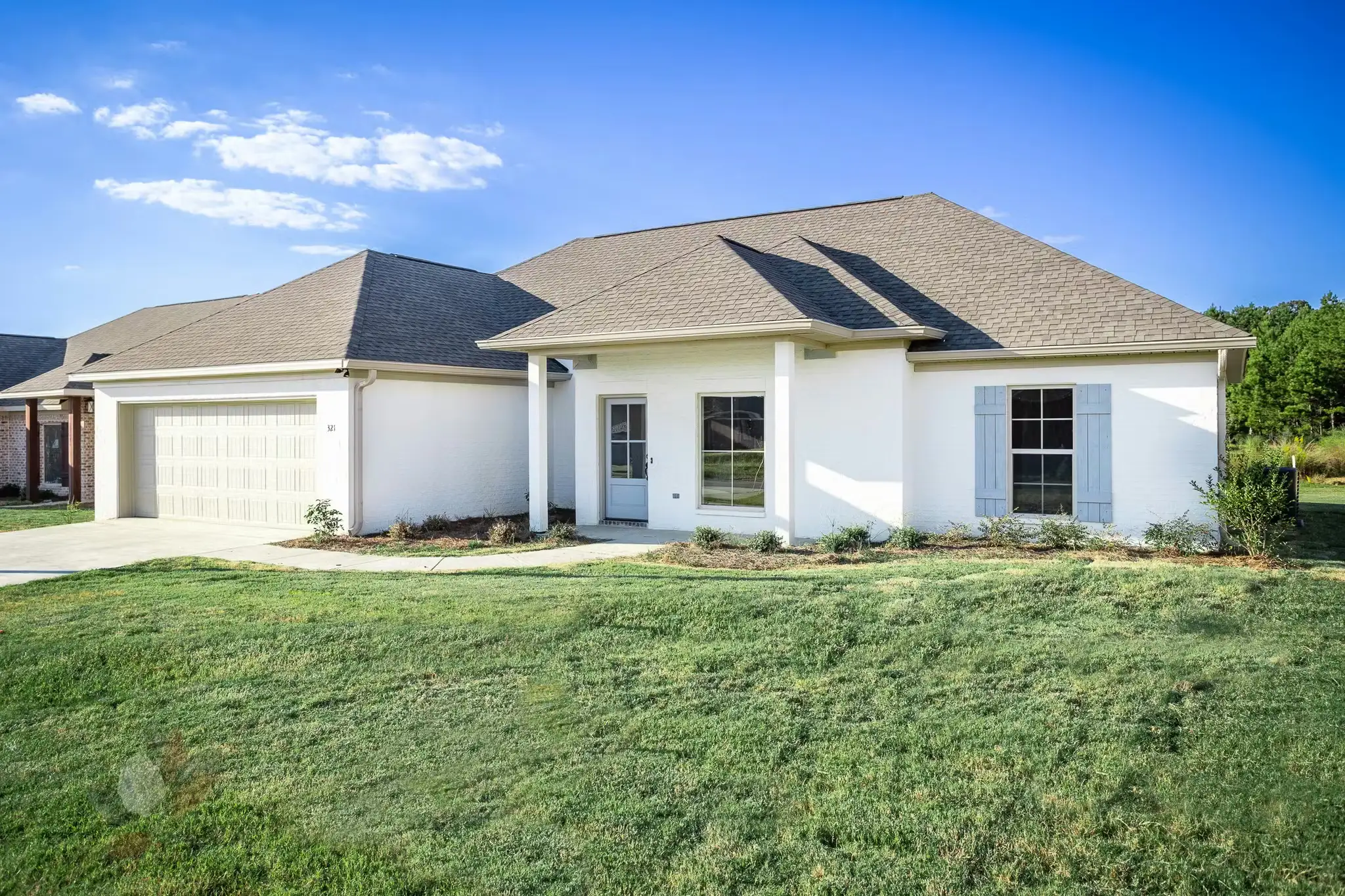 Ranch style home with hip roof and front porch